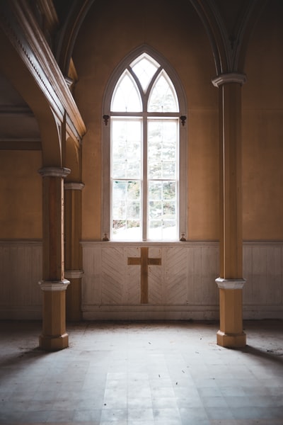 Brown brown wooden cross on the wooden door
